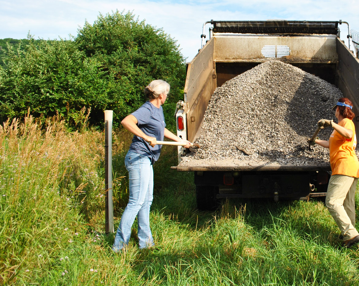 Installing Stone Mulch at Buffer Project